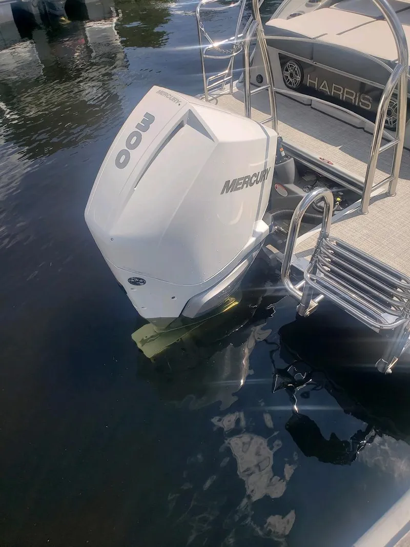 Slide: The Image of 2023 Harris Grand Mariner 230 boat with Mercury outboard motor in water. - 4