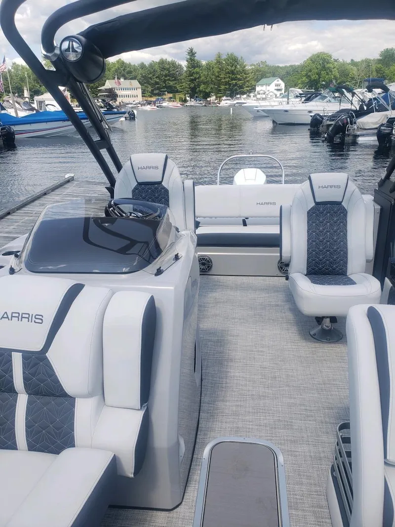 Slide: The Image of 2023 Harris Grand Mariner 230 pontoon boat interior at a marina. - 5