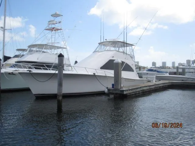 The Image of 2004 Ocean Yachts Super Sport docked at a marina on a sunny day. - 0