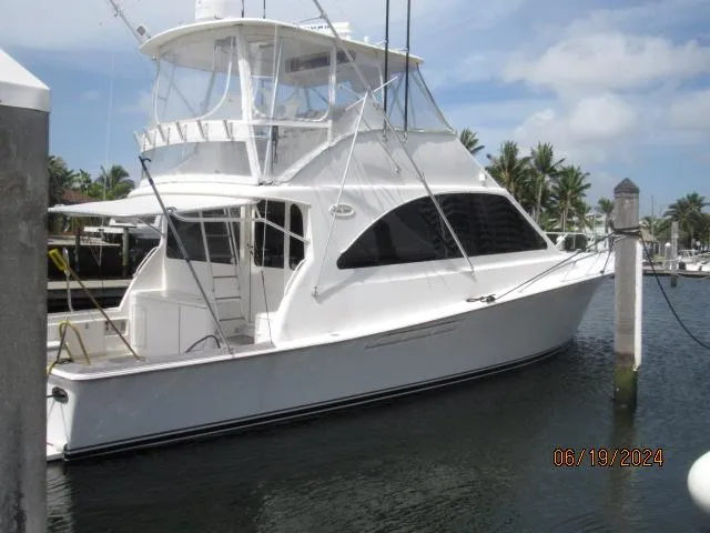 Slide: The Image of 2004 Ocean Yachts Super Sport docked at a marina on a sunny day. - 1