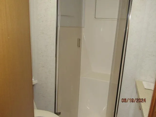 Slide: The Image of Bathroom shower area in a 2004 Ocean Yachts Super Sport. - 23