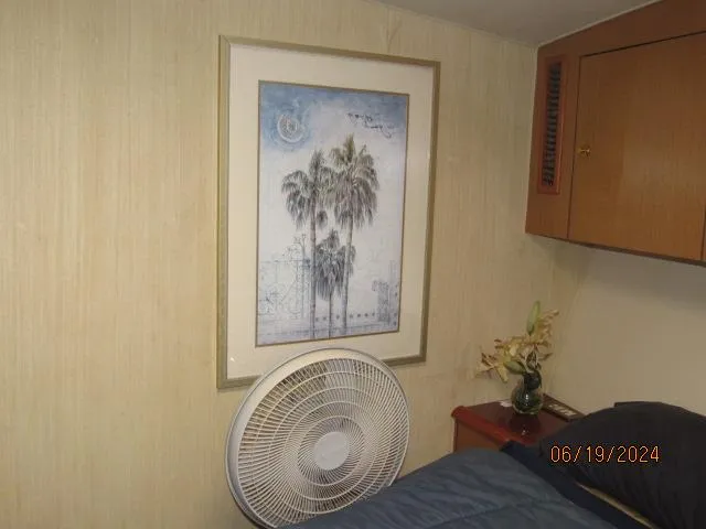 Slide: The Image of Framed palm tree artwork in a 2004 Ocean Yachts Super Sport cabin. - 24