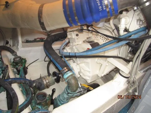 Slide: The Image of Engine room of a 2004 Ocean Yachts Super Sport with various hoses and components. - 28