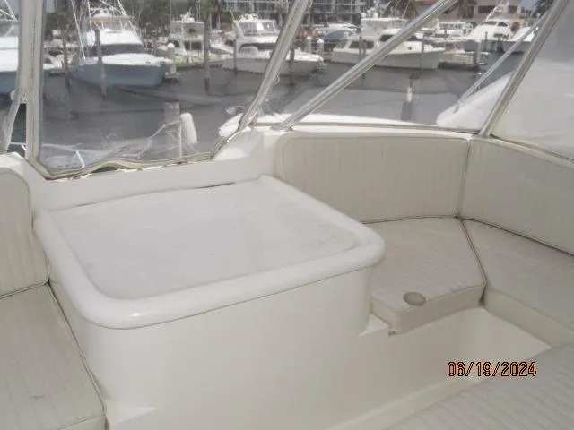 Slide: The Image of 2004 Ocean Yachts Super Sport interior seating area with marina view. - 7