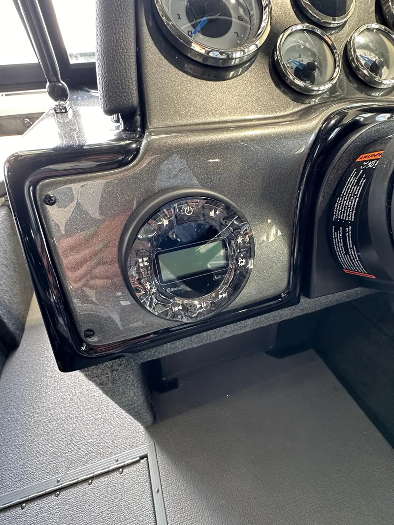 Slide: The Image of 2024 Smoker Craft Ultima 182 boat dashboard with gauges and controls. - 21
