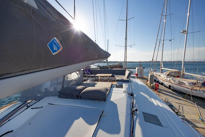 Slide: The Image of 2023 Fountaine Pajot Tanna 47 catamaran docked in a sunny marina. - 10