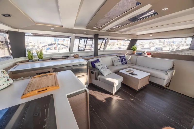 Slide: The Image of Luxurious interior of 2023 Fountaine Pajot Tanna 47 catamaran with modern furnishings and panoramic windows. - 25