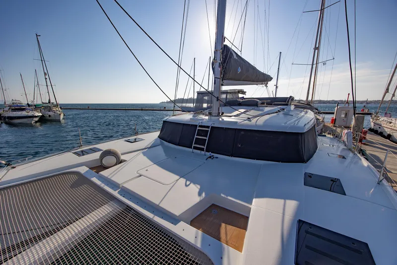Slide: The Image of 2023 Fountaine Pajot Tanna 47 catamaran docked at marina, sunny day. - 3