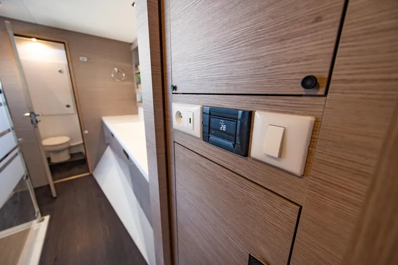 Slide: The Image of Interior of 2023 Fountaine Pajot Tanna 47 yacht, featuring modern bathroom and control panel. - 38