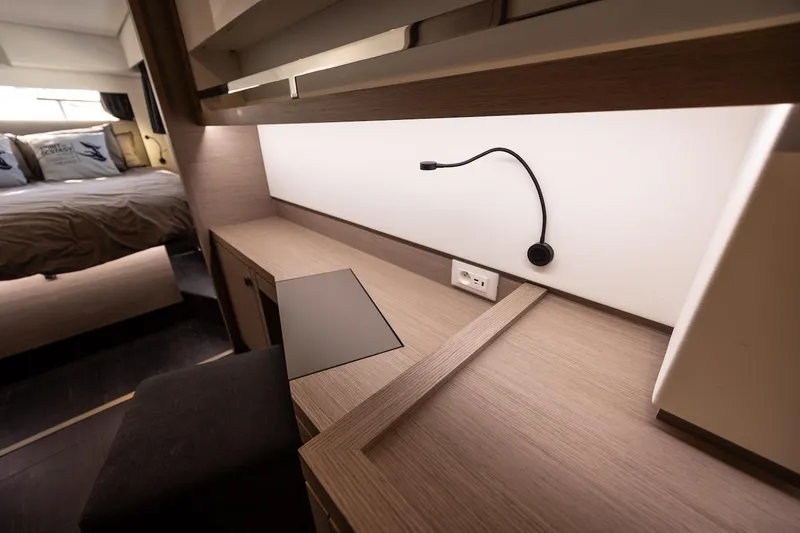 Slide: The Image of Interior of 2023 Fountaine Pajot Tanna 47 yacht, featuring a modern desk and cozy bedroom. - 42