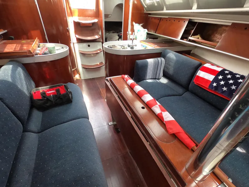 Slide: The Image of Interior of a 1992 Beneteau First 35s5 yacht with blue upholstery. - 10