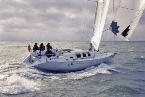 Slide: The Image of 1992 Beneteau First 35s5 sailboat navigating open waters. - 12