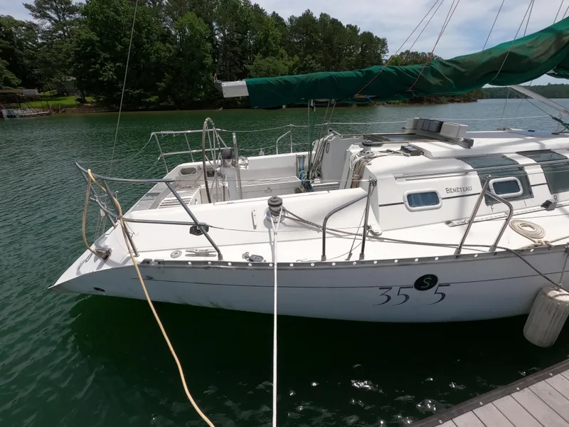 Slide: The Image of 1992 Beneteau First 35s5 sailboat docked on calm water. - 2
