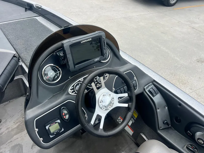 Slide: The Image of 2009 Ranger 208 VX boat dashboard with steering wheel and navigation system. - 18