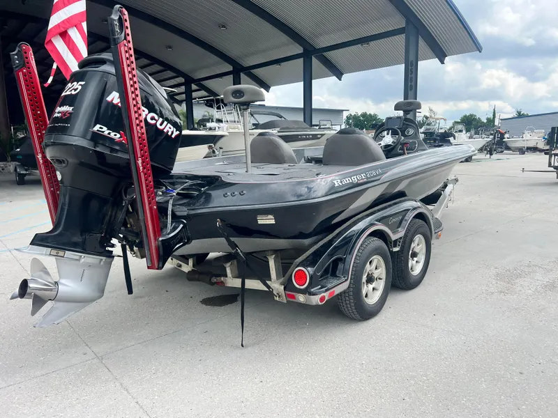 Slide: The Image of 2009 Ranger 208 VX boat with Mercury engine in a marina setting. - 9