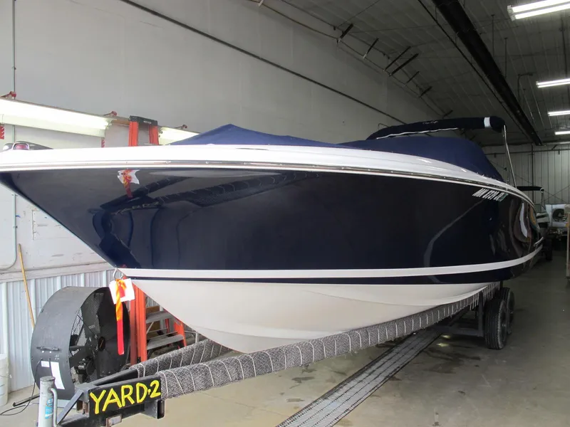 The Image of 2003 Chris-Craft Launch 28 boat in storage on a trailer. - 1