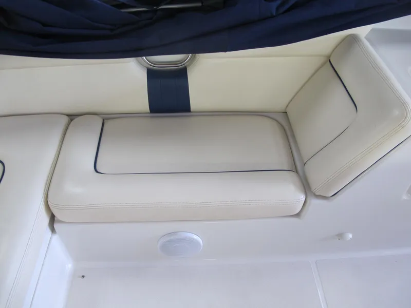 Slide: The Image of 2003 Chris-Craft Launch 28 boat interior seating with white and blue upholstery. - 14