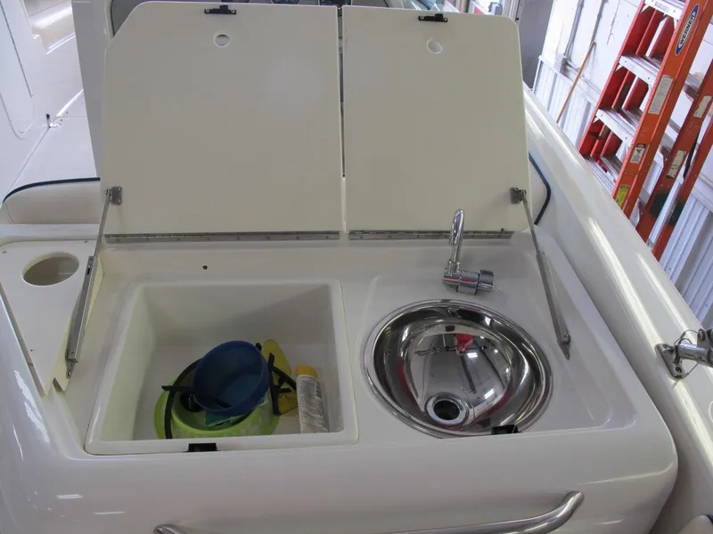 Slide: The Image of 2003 Chris-Craft Launch 28 boat sink and storage compartment. - 15