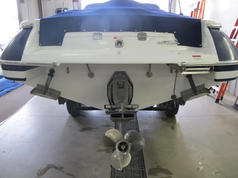 Slide: The Image of 2003 Chris-Craft Launch 28 boat stern view with propeller and covered deck. - 3