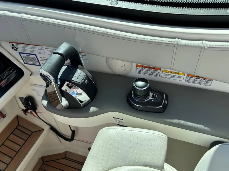 Slide: The Image of Control panel of a 2021 Sea Ray 320 DA boat with joystick and throttle. - 13