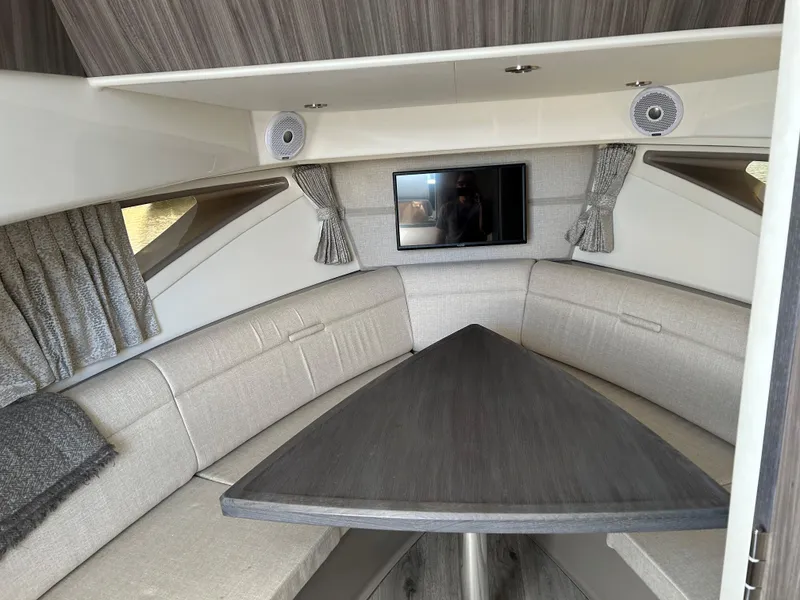 Slide: The Image of Interior of 2021 Sea Ray 320 DA with modern seating and TV. - 28
