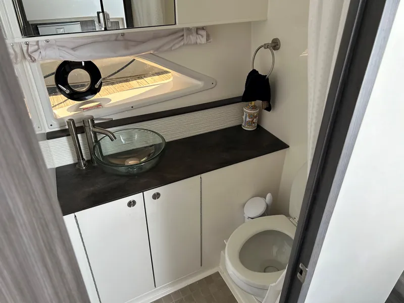 Slide: The Image of Modern bathroom in 2021 Sea Ray 320 DA boat with glass sink and toilet. - 31