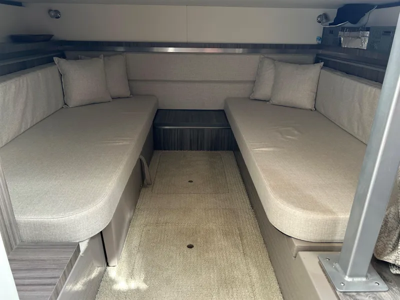 Slide: The Image of Interior cabin of 2021 Sea Ray 320 DA with beige seating and cushions. - 33