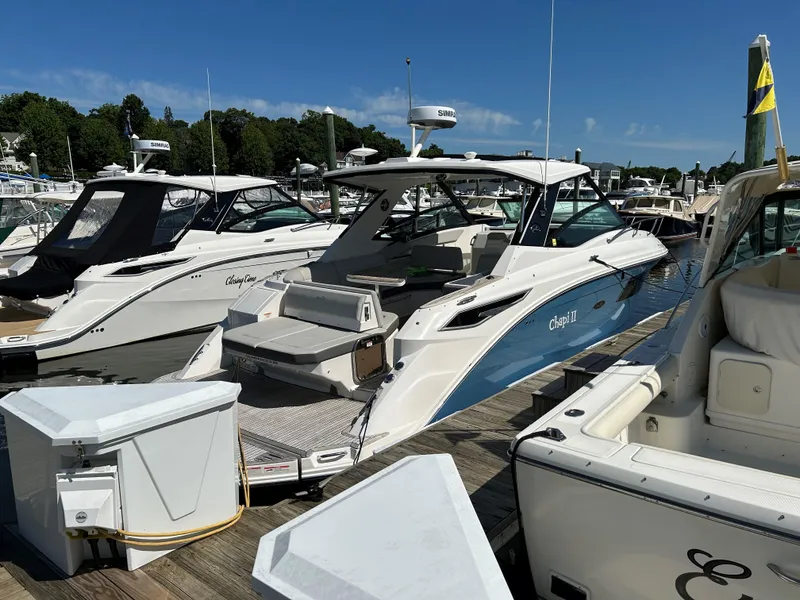 Slide: The Image of 2021 Sea Ray 320 DA docked at a marina on a sunny day. - 4