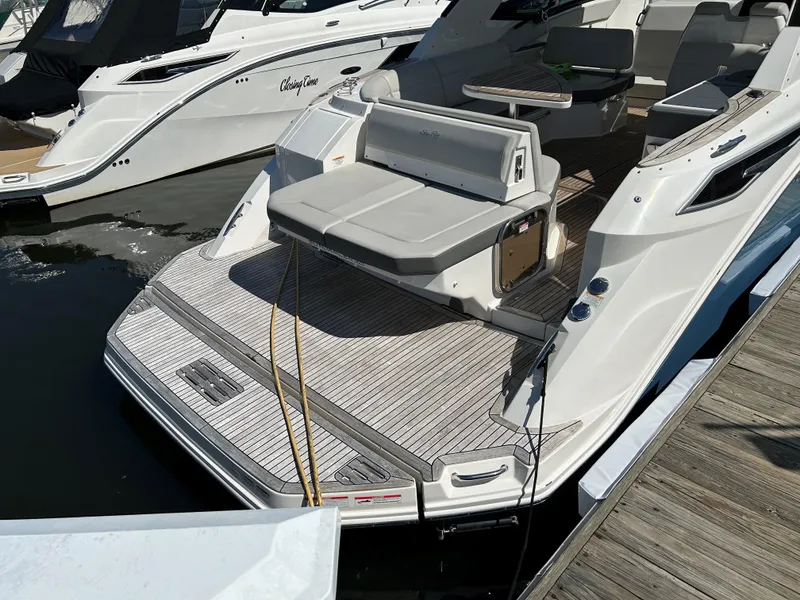 Slide: The Image of Sea Ray 320 DA 2021 model docked, featuring spacious rear deck and seating area. - 5