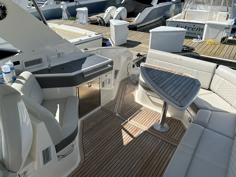 Slide: The Image of Sea Ray 320 DA 2021 model boat interior with seating and table. - 7