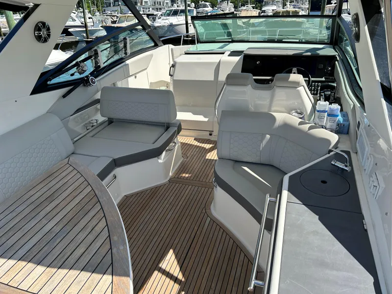 Slide: The Image of 2021 Sea Ray 320 DA boat interior with spacious seating and modern design. - 9