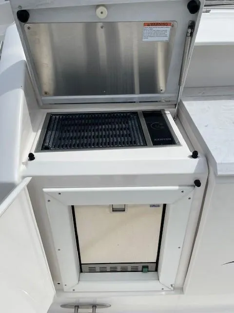Slide: The Image of 2019 Tiara Yachts C53 Coupe built-in grill and refrigerator. - 10