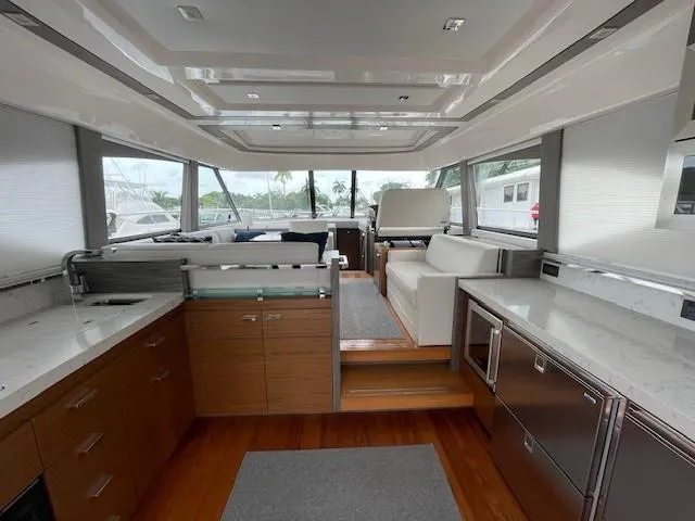Slide: The Image of 2019 Tiara Yachts C53 Coupe interior with modern kitchen and seating area. - 11