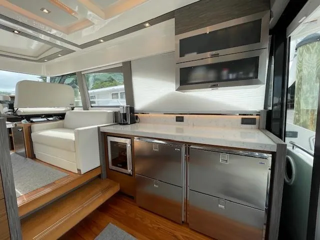 Slide: The Image of Modern kitchen area in 2019 Tiara Yachts C53 Coupe with stainless steel appliances. - 12