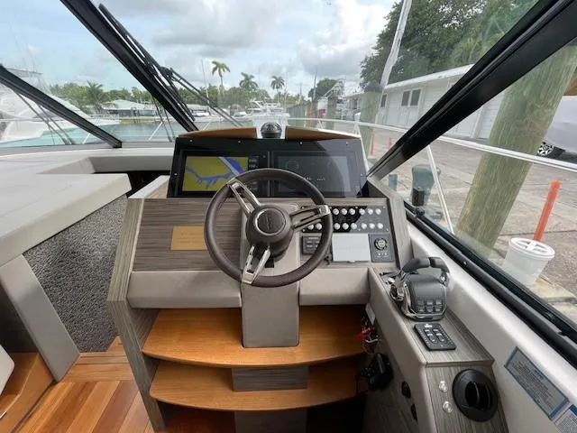 Slide: The Image of 2019 Tiara Yachts C53 Coupe helm station with modern navigation equipment. - 16