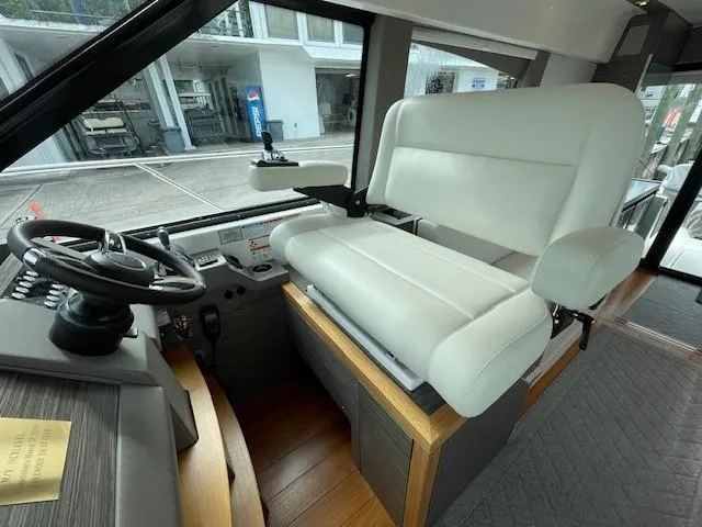 Slide: The Image of Captain's seat and helm of a 2019 Tiara Yachts C53 Coupe. - 18