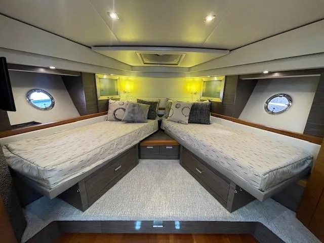 Slide: The Image of 2019 Tiara Yachts C53 Coupe interior cabin with twin beds and modern lighting. - 25