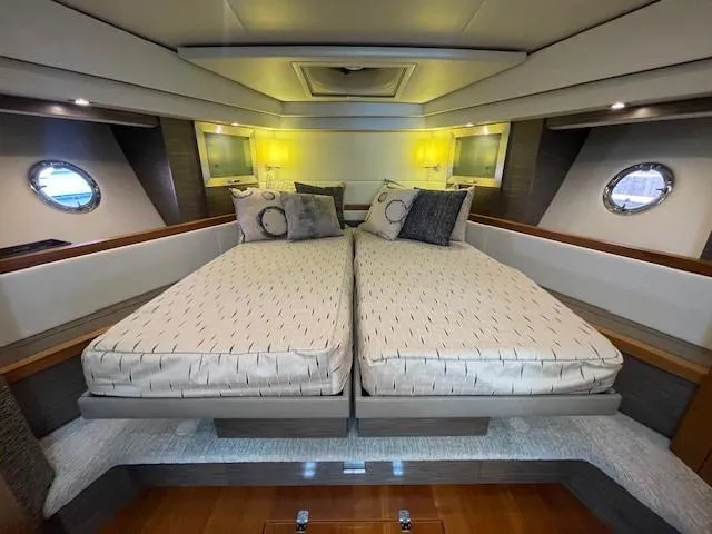 Slide: The Image of 2019 Tiara Yachts C53 Coupe bedroom with twin beds and modern decor. - 26