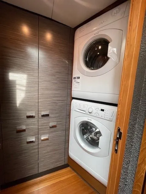 Slide: The Image of Stacked washer and dryer in 2019 Tiara Yachts C53 Coupe laundry area. - 28