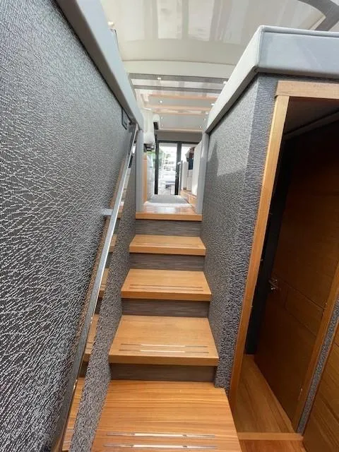Slide: The Image of Staircase inside 2019 Tiara Yachts C53 Coupe, modern yacht interior design. - 29