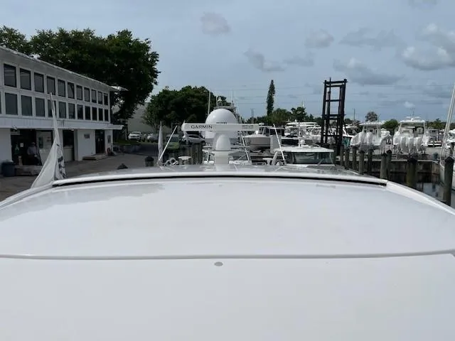 Slide: The Image of 2019 Tiara Yachts C53 Coupe docked at a marina with other boats. - 3