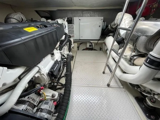 Slide: The Image of Engine room of a 2019 Tiara Yachts C53 Coupe with visible machinery and equipment. - 32