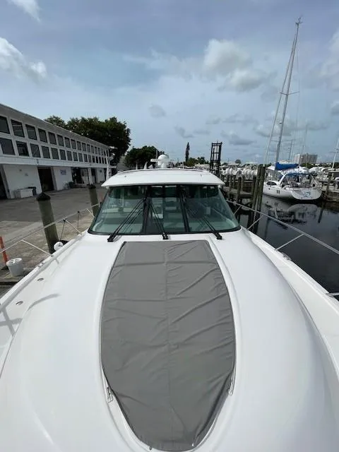 Slide: The Image of 2019 Tiara Yachts C53 Coupe docked at a marina, front deck view. - 5