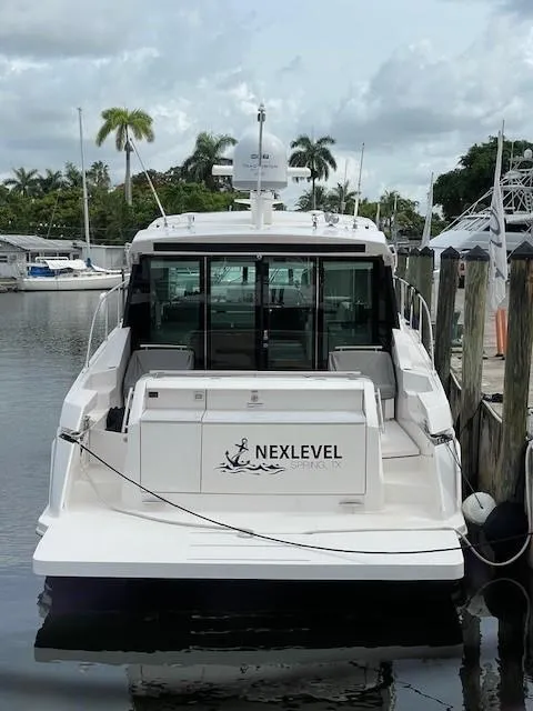 Slide: The Image of 2019 Tiara Yachts C53 Coupe docked at marina, rear view. - 7