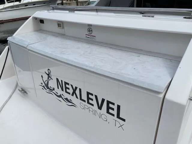 Slide: The Image of 2019 Tiara Yachts C53 Coupe with NexLevel Spring, TX branding on the stern. - 9