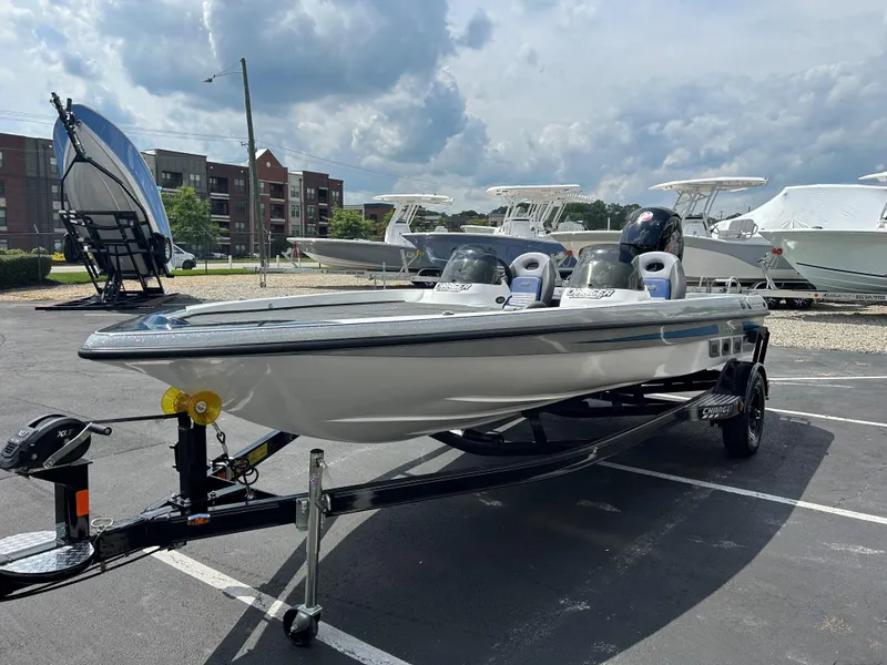 Slide: The Image of 2022 Charger Bass Boat 176 on trailer in marina parking lot. - 3