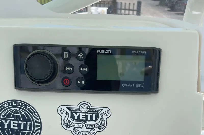 Slide: The Image of Fusion MS-RA70N marine stereo on a 2016 Skeeter SX 240 boat with Yeti stickers. - 13