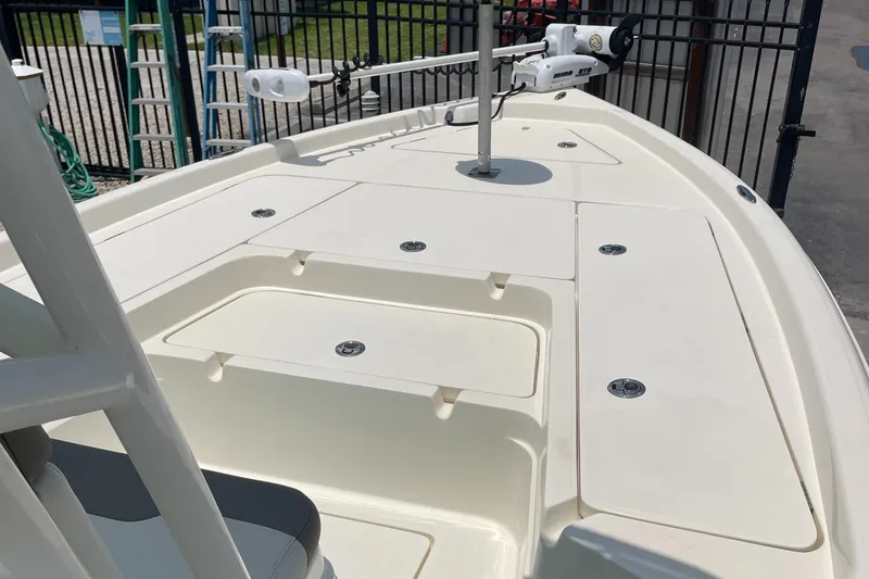 Slide: The Image of 2016 Skeeter SX 240 boat deck with storage compartments and trolling motor. - 16
