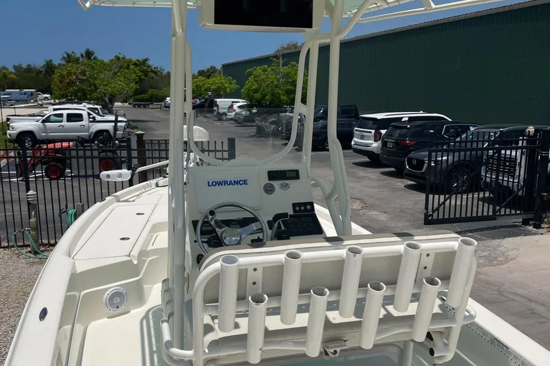 Slide: The Image of 2016 Skeeter SX 240 boat with Lowrance electronics and rod holders in a parking lot. - 2
