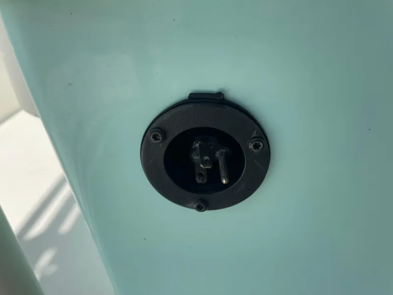 Slide: The Image of Close-up of a 2016 Skeeter SX 240 boat electrical outlet. - 8